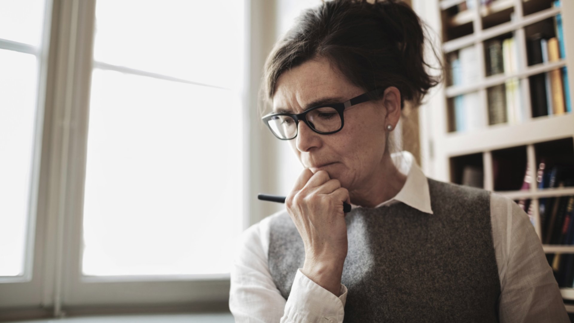 Woman with glasses hand on chin